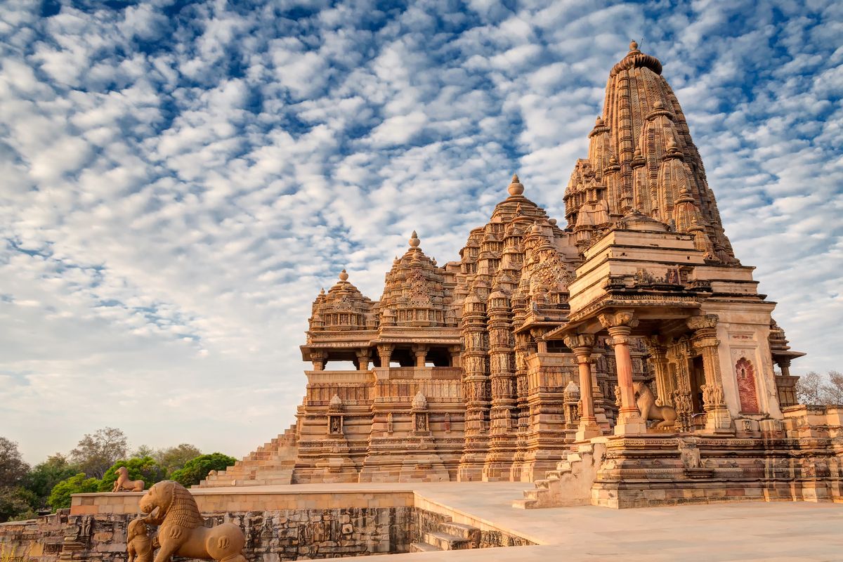 Beautiful image of Kandariya Mahadeva temple, Khajuraho, Madhyapradesh, India with blue sky and fluffy clouds in the background, It is worldwide famous ancient temples in India, UNESCO world heritage site.